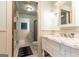 Elegant bathroom featuring marble countertops, white cabinetry, and a glass-enclosed shower at 4421 Paradise Cir, Vinings, GA 30339