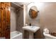 This bathroom features a traditional vanity, pedestal sink, and shower with wood-look accents at 4421 Paradise Cir, Vinings, GA 30339