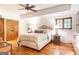 Cozy bedroom with hardwood floors, a ceiling fan, and decorative bedside lamps at 4421 Paradise Cir, Vinings, GA 30339