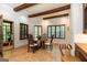 Dining room with wood beams, shuttered windows, tile floors and a view to an adjacent outdoor area at 4421 Paradise Cir, Vinings, GA 30339