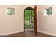 Arched doorway opening to a view of lush greenery and trees in a private wooded backyard at 4421 Paradise Cir, Vinings, GA 30339