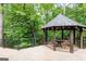 Charming gazebo with wooden table and seating on an outdoor deck at 4421 Paradise Cir, Vinings, GA 30339