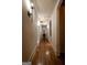 Long hallway with hardwood floors and decorative lighting fixtures at 4421 Paradise Cir, Vinings, GA 30339