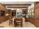 A kitchen with stainless steel appliances, custom cabinets, a stone backsplash and an island with seating is ready for entertaining at 4421 Paradise Cir, Vinings, GA 30339