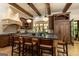Spacious kitchen featuring custom cabinets, stainless steel appliances, an island with seating, and pendant lighting at 4421 Paradise Cir, Vinings, GA 30339