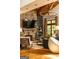 Cozy living room featuring a stone fireplace, large TV and wood beam ceiling at 4421 Paradise Cir, Vinings, GA 30339