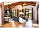Spacious living room boasts a stone fireplace, wood beams, and large windows bringing the outside in at 4421 Paradise Cir, Vinings, GA 30339