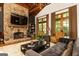 Stylish living room showcases a stone fireplace, wood beams, and modern furniture for ultimate comfort at 4421 Paradise Cir, Vinings, GA 30339
