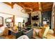 Bright living room boasts wood beams, a stone fireplace, and elegant furnishings, creating a cozy atmosphere at 4421 Paradise Cir, Vinings, GA 30339