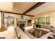 Comfortable living room with a stone fireplace and large windows overlooking the greenery at 4421 Paradise Cir, Vinings, GA 30339