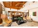 Spacious living room with wood beam ceilings, modern chandelier and comfortable furniture at 4421 Paradise Cir, Vinings, GA 30339