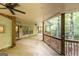 Expansive covered patio featuring ceiling fans, wood railings, and views of the surrounding trees at 4421 Paradise Cir, Vinings, GA 30339