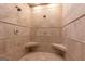 Elegant tiled walk in shower featuring dual shower heads and a built in corner seat at 4421 Paradise Cir, Vinings, GA 30339