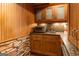 Home wet bar area with granite countertops, wood cabinetry, and a backsplash at 4421 Paradise Cir, Vinings, GA 30339