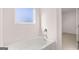 Clean, well-lit bathroom showcases a white tub and silver fixtures at 624 Kimberwick Dr, Locust Grove, GA 30248