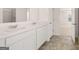 Elegant bathroom featuring double vanities with marble countertops and modern fixtures at 624 Kimberwick Dr, Locust Grove, GA 30248