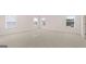 Spacious bedroom with plush carpeting, two windows letting in natural light, and a pristine, modern feel at 624 Kimberwick Dr, Locust Grove, GA 30248