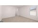 This bedroom has neutral carpet, white walls and trim, and windows for natural light at 624 Kimberwick Dr, Locust Grove, GA 30248