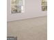This bedroom has neutral carpet, white walls and trim, and windows for natural light at 624 Kimberwick Dr, Locust Grove, GA 30248