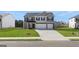 New construction two-story home with gray siding, two-car garage, and manicured front lawn at 624 Kimberwick Dr, Locust Grove, GA 30248