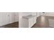 Hallway view featuring white cabinets and grey granite countertop next to a hallway door and wooden floors at 624 Kimberwick Dr, Locust Grove, GA 30248