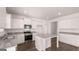 Modern kitchen featuring white cabinets, stainless steel appliances and a central island with granite countertop at 624 Kimberwick Dr, Locust Grove, GA 30248