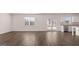 Bright living room featuring hardwood floors, natural light, and access to the outdoors at 624 Kimberwick Dr, Locust Grove, GA 30248