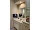 Bathroom featuring a vanity with cabinets, sink, mirror, and blue towels offering a functional space at 1205 Dover Pl, Conyers, GA 30013