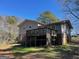 Exterior shot of a split-level home with a large wooden deck, staircase and a large backyard at 4935 Liberty Sw Ct, Stone Mountain, GA 30087