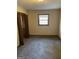 Neutral bedroom featuring a window for natural light and a closet for storage at 4935 Liberty Sw Ct, Stone Mountain, GA 30087