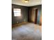 Dark-walled bedroom with a window providing natural light and two closets for ample storage at 4935 Liberty Sw Ct, Stone Mountain, GA 30087