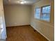 Bright bedroom with hardwood floors, a large double window, and closet for storage at 4935 Liberty Sw Ct, Stone Mountain, GA 30087