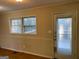 A dining room space featuring a window, door, and neutral-colored walls at 4935 Liberty Sw Ct, Stone Mountain, GA 30087