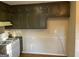 Galley kitchen featuring abundant cabinetry and neutral countertops at 4935 Liberty Sw Ct, Stone Mountain, GA 30087