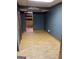 Room featuring wood-look floors, dark walls, and access to additional rooms at 4935 Liberty Sw Ct, Stone Mountain, GA 30087