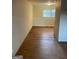 Neutral-toned walls with wood-look flooring, natural light streams through the windows in this inviting room at 4935 Liberty Sw Ct, Stone Mountain, GA 30087