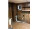 Utility room with wood paneled walls, wood-look floors, shelves, and utility sink at 4935 Liberty Sw Ct, Stone Mountain, GA 30087