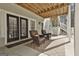 Covered back porch with comfortable seating and views of the backyard at 605 St. Charles Pl, Fayetteville, GA 30215