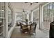 Relaxing screened back porch with seating, ceiling fans, and wooded views at 605 St. Charles Pl, Fayetteville, GA 30215