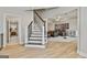 Finished basement with modern light wood flooring leading to stairs and a home theater space at 605 St. Charles Pl, Fayetteville, GA 30215