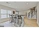 Basement entertaining space features custom bar, dart board, and wood-look flooring at 605 St. Charles Pl, Fayetteville, GA 30215