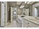 Elegant bathroom with double vanity, mirrors and neutral-toned tile flooring at 605 St. Charles Pl, Fayetteville, GA 30215