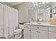 Bathroom featuring white cabinets, neutral walls and shower and toilet at 605 St. Charles Pl, Fayetteville, GA 30215