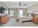 Cozy bedroom featuring a ceiling fan, two windows, carpet flooring, and classic furnishings at 605 St. Charles Pl, Fayetteville, GA 30215