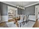 Cozy dining room with pendant lighting, hardwood floors, and a view into the foyer at 605 St. Charles Pl, Fayetteville, GA 30215