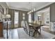 Dining room featuring hardwood floors, gray walls, neutral furniture, and light-filled windows at 605 St. Charles Pl, Fayetteville, GA 30215