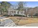 Charming white clubhouse exterior with inviting porch, nestled near pool and picturesque landscaping at 605 St. Charles Pl, Fayetteville, GA 30215
