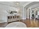 Elegant foyer featuring stylish decor, warm lighting, hardwood floors, and open sightlines at 605 St. Charles Pl, Fayetteville, GA 30215