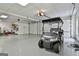 Spacious three car garage with a golf cart parked on the epoxy flooring at 605 St. Charles Pl, Fayetteville, GA 30215