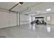 Clean, epoxy-coated garage with three bays and a golf cart parked within at 605 St. Charles Pl, Fayetteville, GA 30215